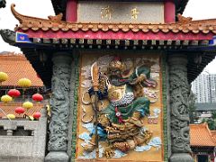 03B Guard Ganam menshen holds a giant guandao and protects against evil influences at entrance to Wong Tai Sin temple Hong Kong